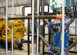 Photo of a heat exchanger that works in conjunction with an engine-generator set to recover heat for space and water heating, thus reducing fuel oil or propane costs.