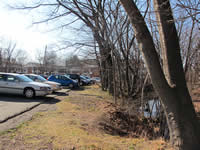 [Before Construction] Northern side of parking lot, adjacent to Mill Brook