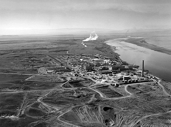 N reactor shown in the foreground with the KE and KW reactors in the background along the Columbia River circa 1960. B Reactor is shown in the distance.