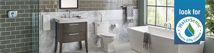 Image of a tiled bathroom with a large window.