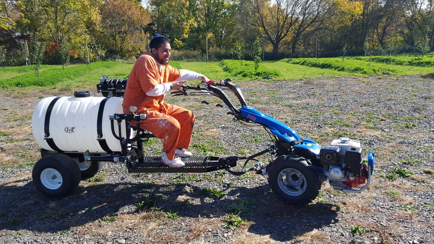 This is a picture of someone from the City of Philadelphia Department of Prisons riding what appears to be a composter.