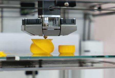 3D printer printing a yellow object