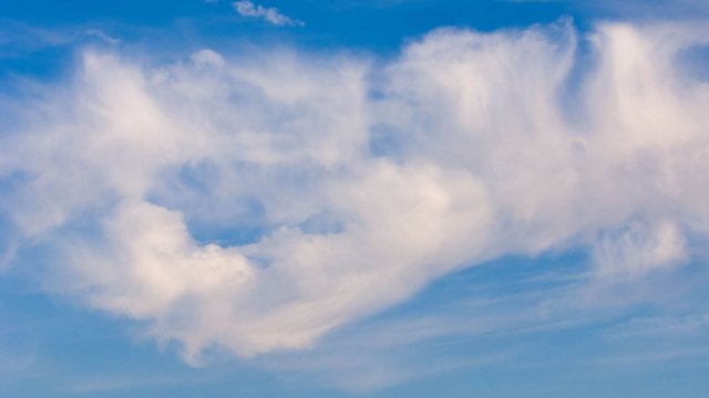 Fluffy clouds against a clear blue sky