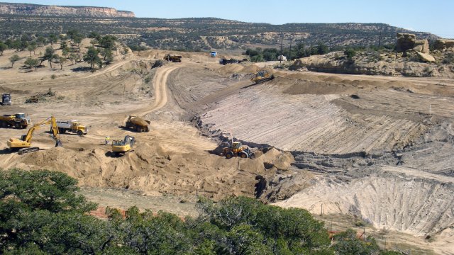desert landscape with large construction equipment at work