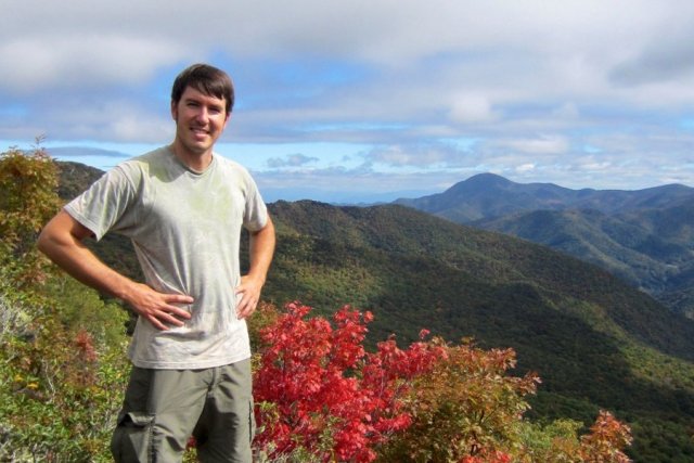 EPA research Justine Clonley stands on top of a mountain