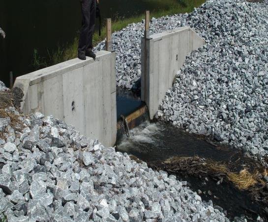 Clear water flowing through in a channel between two cement slabs as the last step in the treatment process