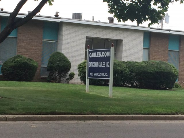 Building and sign for Datacomm Cables, a commercial retail business that sells cables and electronics accessories, which currently operates on the SMS Industries, Inc. site