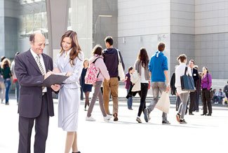 Outdoor plaza with office workers walking