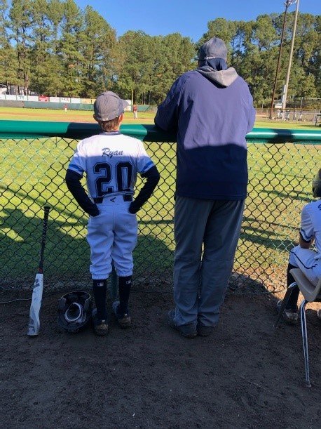 Dr.  Ryan, with his son, in his favorite thinking spot: reflecting, teaching, and learning together. 