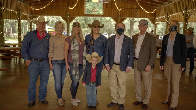 photo of Wheeler in a mask and others in a barn