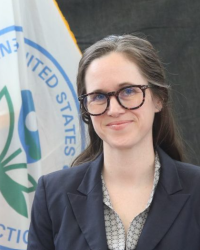 Jenna Hartley in front of an EPA seal flag