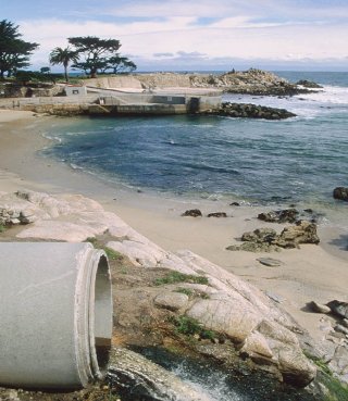 Pipe discharging water onto a beach