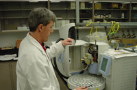 Chemist loading samples on automatic sampler for volatile organic analysis (voa).
