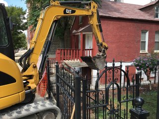 Wheel loader moving stockpiled soil to dump truck in Heart of Chicago