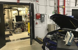 This photo shows a test vehicle’s engine connected to an engine dynamometer in an EPA test cell waiting to be benchmark tested. 