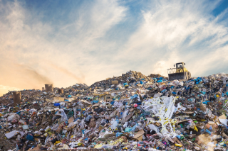 front loader on top of a landfill