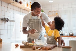 Child baking with dad