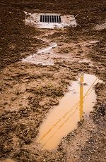 Construction site runoff with water drain and mud