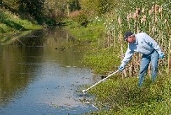 Researcher taking water sample