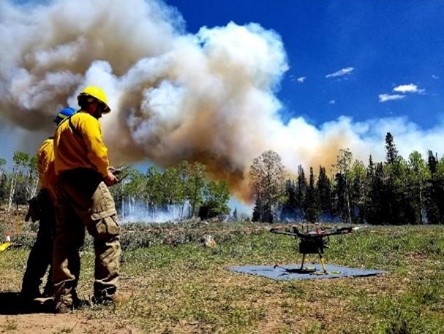 Drone getting ready to take off with smoke in the background.