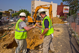 Workers digging up underground storage tank