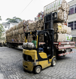 Forklift carrying cardboard