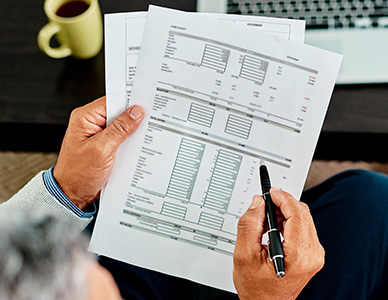 Person holding a report with tables and spreadsheets