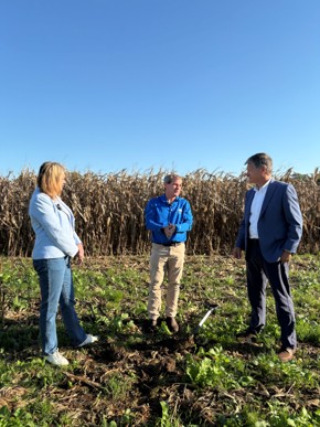 EPA officials and farmer standing in a field.