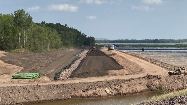 Gravel and stone is placed over the erosion control fabric in the new Unnamed Creek channel and top soil is placed in the Unnamed Creek floodplain.