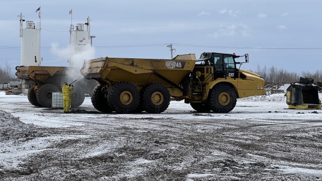 Before being removed from the site, a truck used to transport material from the Shallow Sheltered Bay is decontaminated over an impervious surface that drains to the water treatment facility and captures all impacted materials.