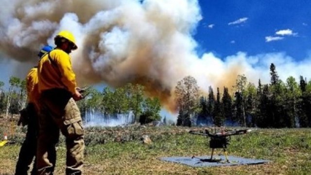 Drone getting ready to take off with smoke in the background.