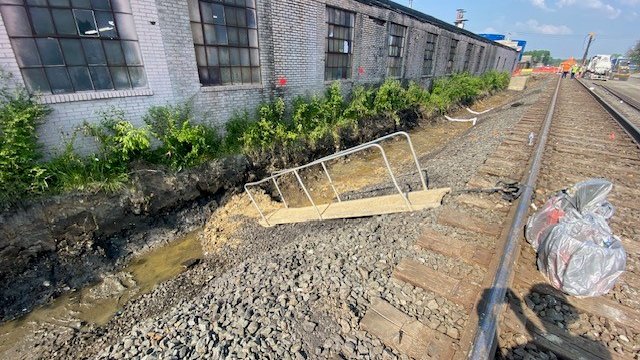 Walkways between the ground and the tracks are used to safely enter the north ditch for sampling