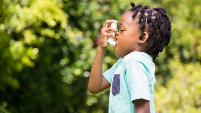 Young child using an inhaler 