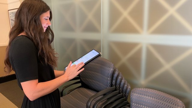 Image of a woman looking at a tablet