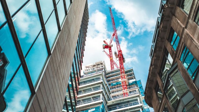 A crane at a construction site in a city. 