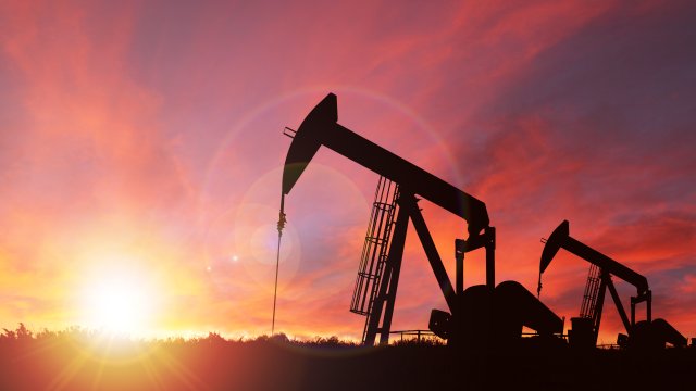 Oil derrick against sunset