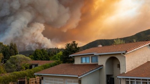 home with wildfire and smoke in background