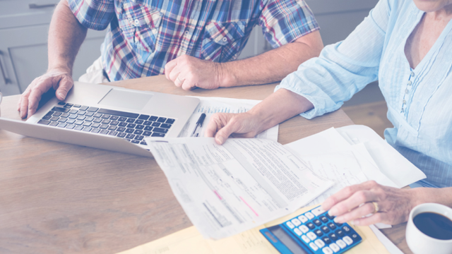 People sitting around table reviewing documents