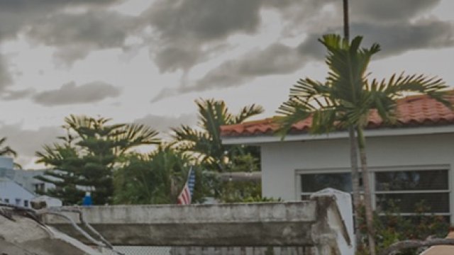 house in shambles after a disaster with a stormy sky