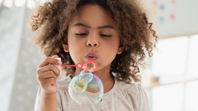 A girl blowing bubbles