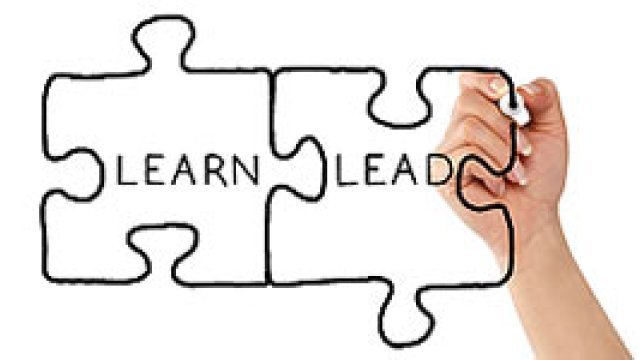Puzzle pieces with the text "Learn" and "Lead" fitting together