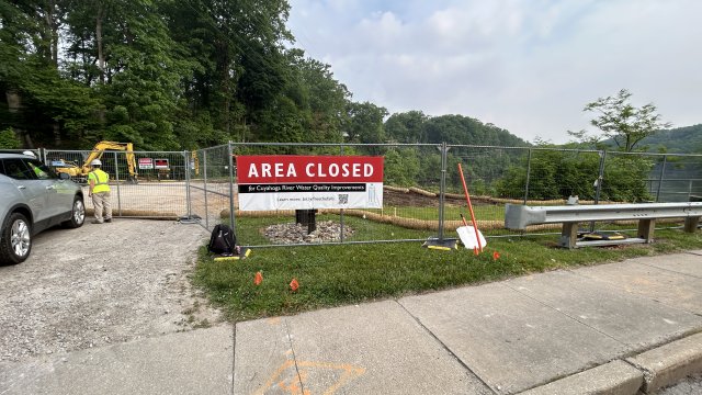 The entrance to cleanup site with a sign that reads "Area Closed"