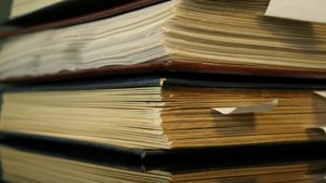 stack of old ledgers on a desk