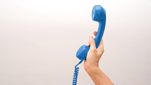 Hand holding phone blue