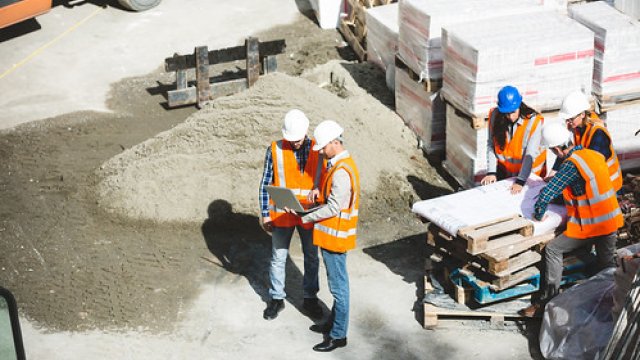 Construction workers reviewing plans