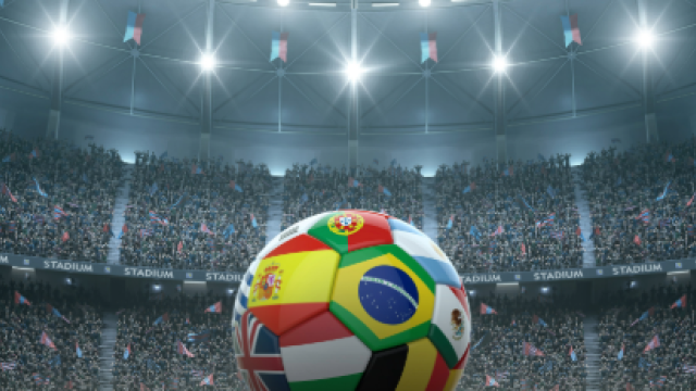 soccer ball with international flags in a stadium