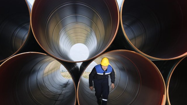 Construction worker walking in water pipe