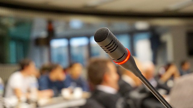 Active microphone with attendees in the background