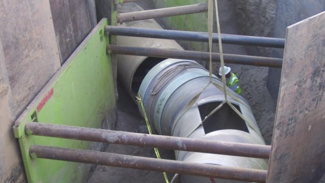 Worker laying interceptor pipe