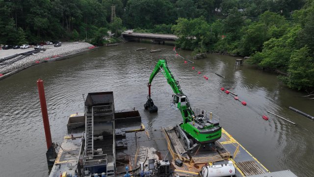 Fine grained sediment dredge operations continue just upstream of Front St. Bridge.